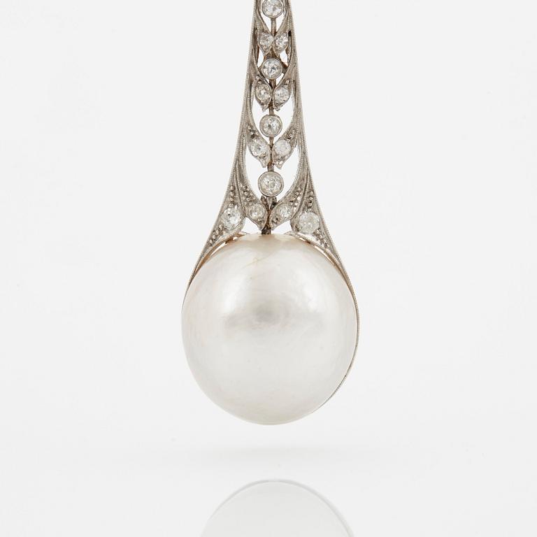 A platinum pendant set with a half pearl and old-cut diamonds.