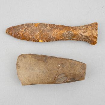 A neolithic flint dagger and an axe.