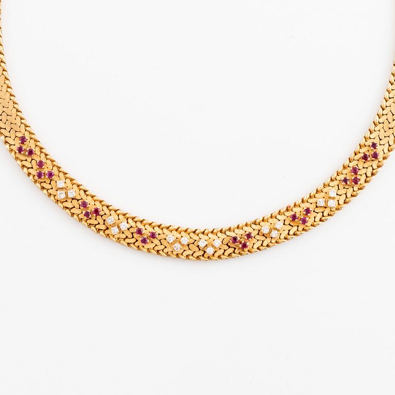 An 18K gold necklace set with round brilliant-cut diamonds and rubies.