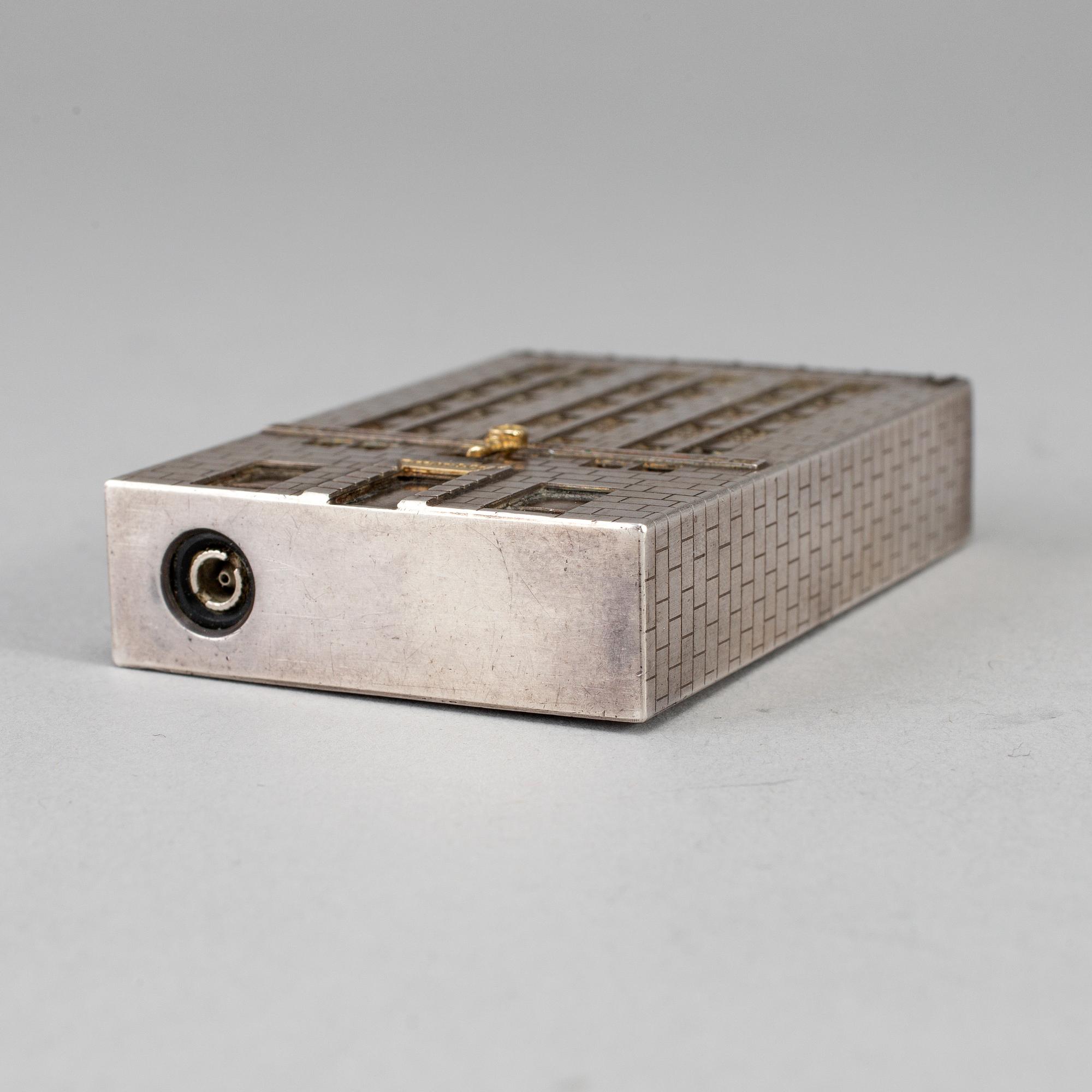 A Tiffany & Co. silver cigarette-lighter, marked London 1970.