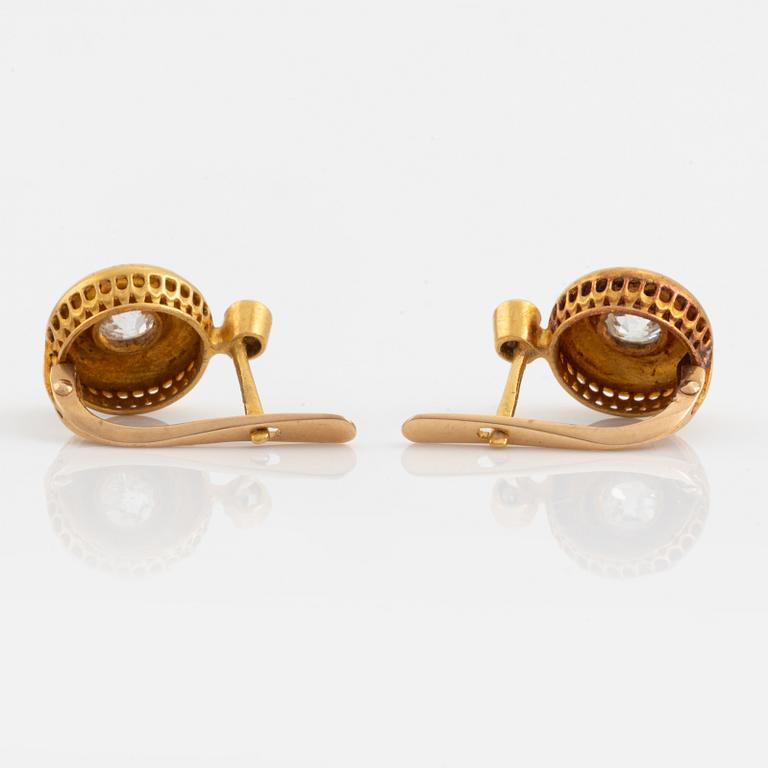 A pair of 18K gold earrings set with old-cut diamonds.