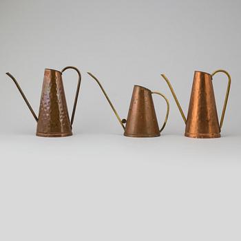 Eight 19th and 20th century copper and brass watering cans.