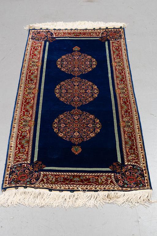 A rug, silk Hereke, ca 143 x 63,5 cm.