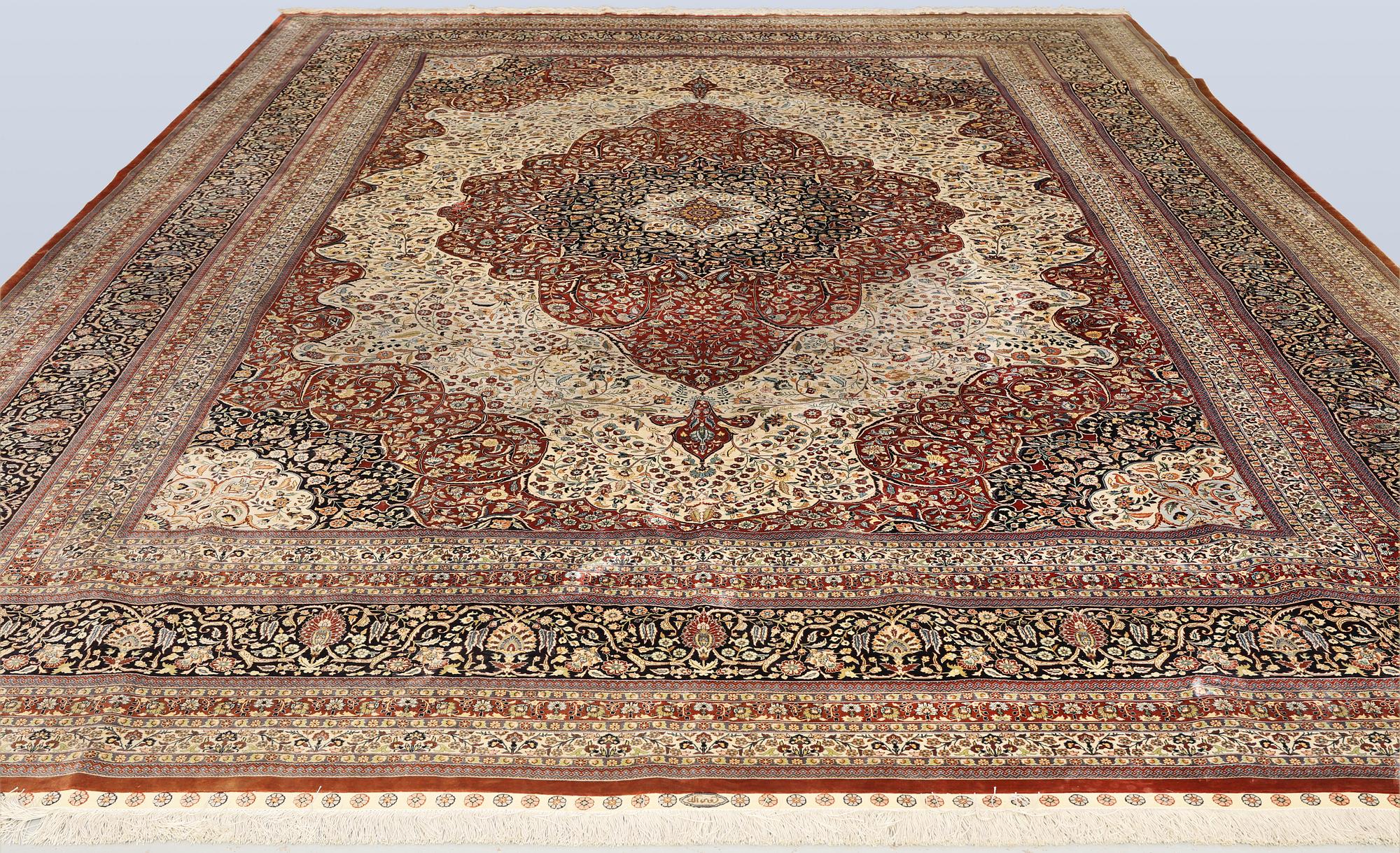 An Oriental silk carpet, c. 436 x 306 cm.