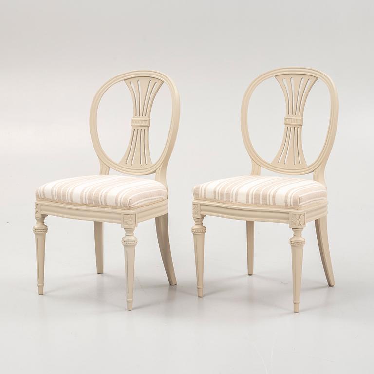 A Gustavian style dining table and eight chairs, late 20th Century.