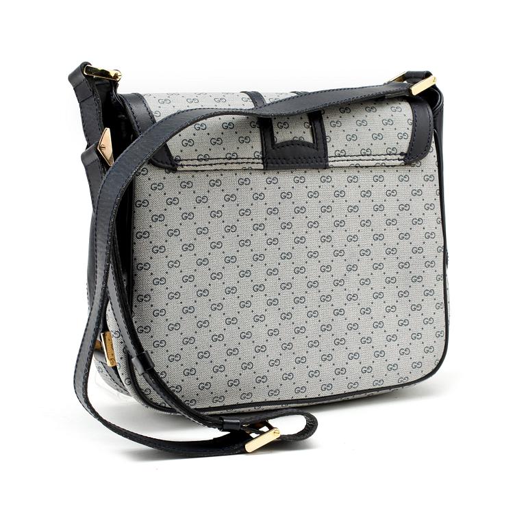 GUCCI, a coated blue monogram canvas shoulder bag.