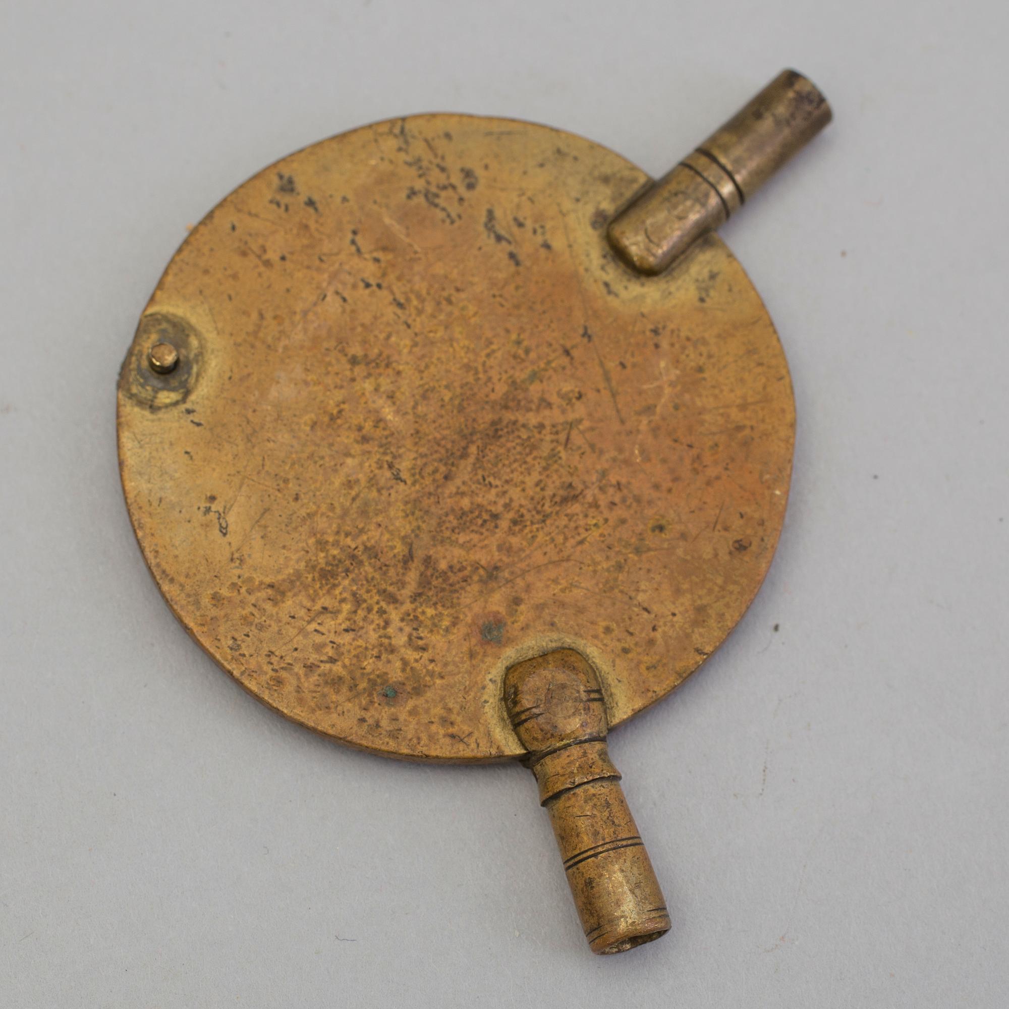 A gilded brass baroque travel clock from around 1700, with original case.