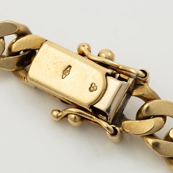 Bracelet in 18K gold set with cabochon-cut emeralds, rubies, and sapphires.