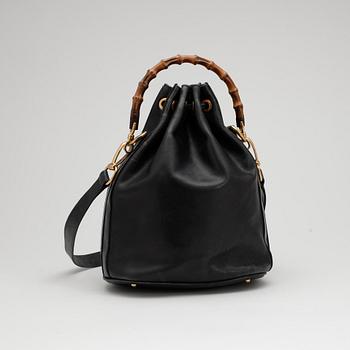 GUCCI, a dark blue leather purse.