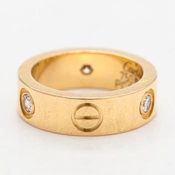 Cartier, an 18K gold 'Love' ring with three brilliant-cut diamonds.