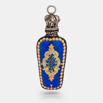 A pendant in the form of a bottle. Made of silver with enamel and opal glass stones. Turn of the 20th century.