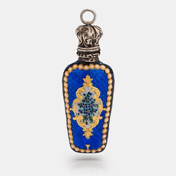 A pendant in the form of a bottle. Made of silver with enamel and opal glass stones. Turn of the 20th century.