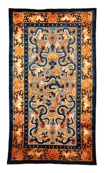 1024. A Chinese antique silk rug in relief, late Qing dynasty (1644–1911). Measurement 218 x 122 cm.