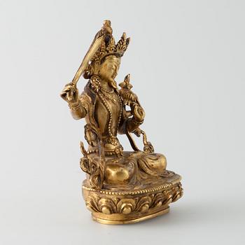 SKULPTUR, "Manjushri", förgylld metallegering, Tibet 1900-talets mitt.