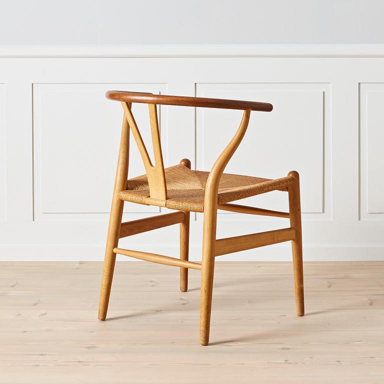 Hans J. Wegner, An early oak and teak 'Wishbone chair' by Carl Hansen & Son, Denmark, 1950's.