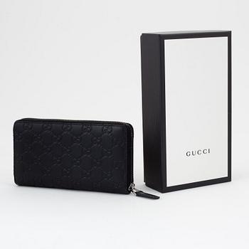 Gucci, an embossed böack leather wallet.