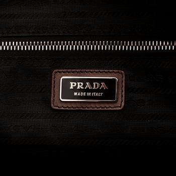 PRADA, a brown leather top handle bag.