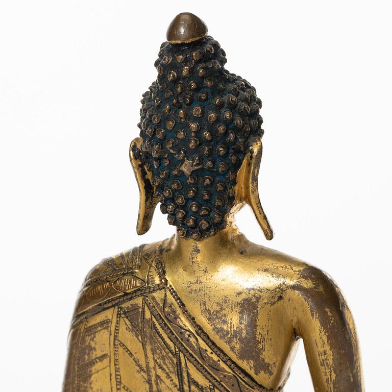 A gilt copper-alloy figure of Aksobhya Buddha, 14th/15th century, Tibet or Nepal.