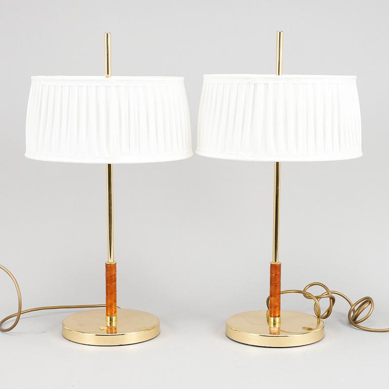 A pair of brass and leather table lights.