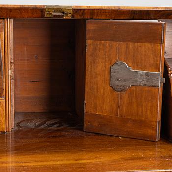 A rococo walnut-veneered and gilt-brass mounted secretaire, later part of the 18th century.