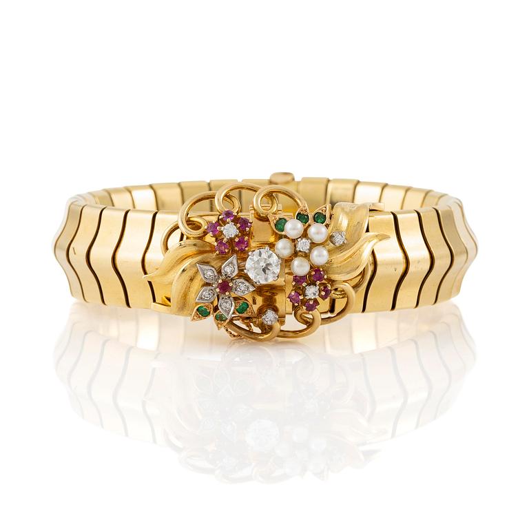 A Strömdahls bracelet/pendant combination in 18K gold with rubies, emeralds, pearls and diamonds.