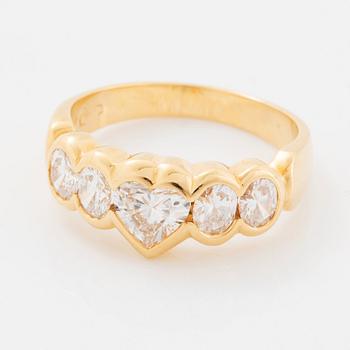 An 18K gold ring set with a heart formed brilliant-cut diamond.