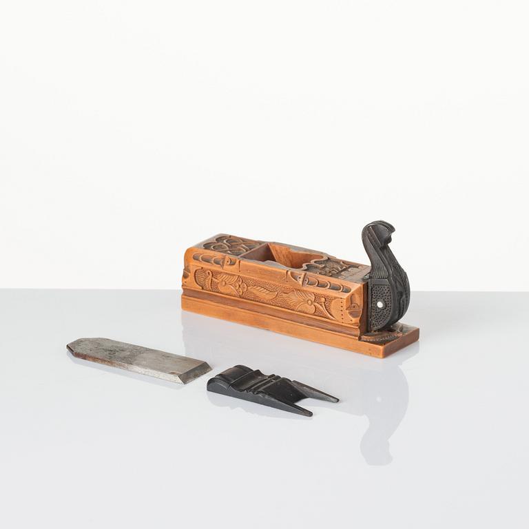 A Swedish carved ebony, boxwood and bone plane, dated 1748.
