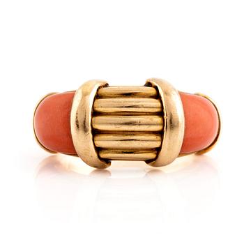 An 18K gold and coral Hermès ring.