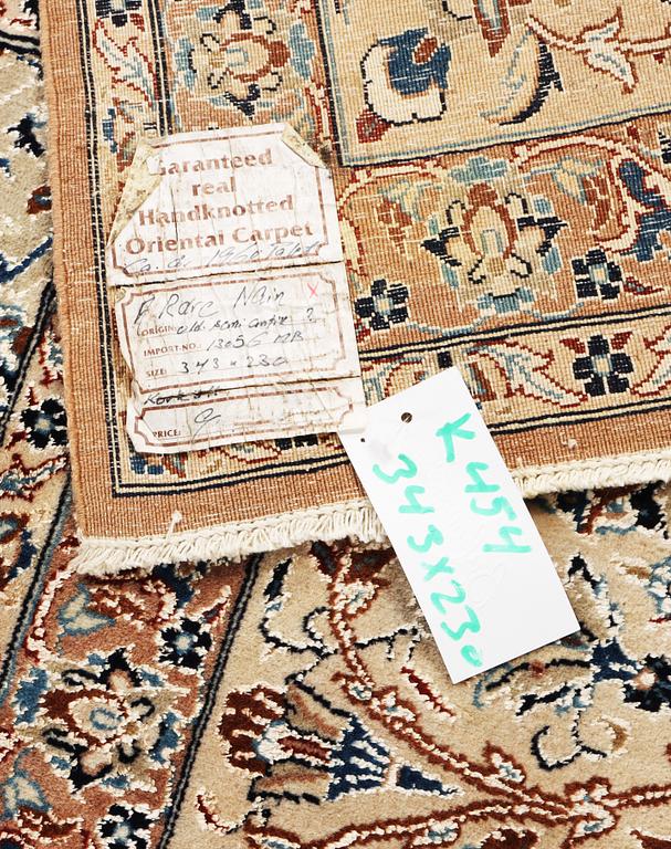 A semi-antique/old Nain carpet, part silk, c. 343 x 230 cm.