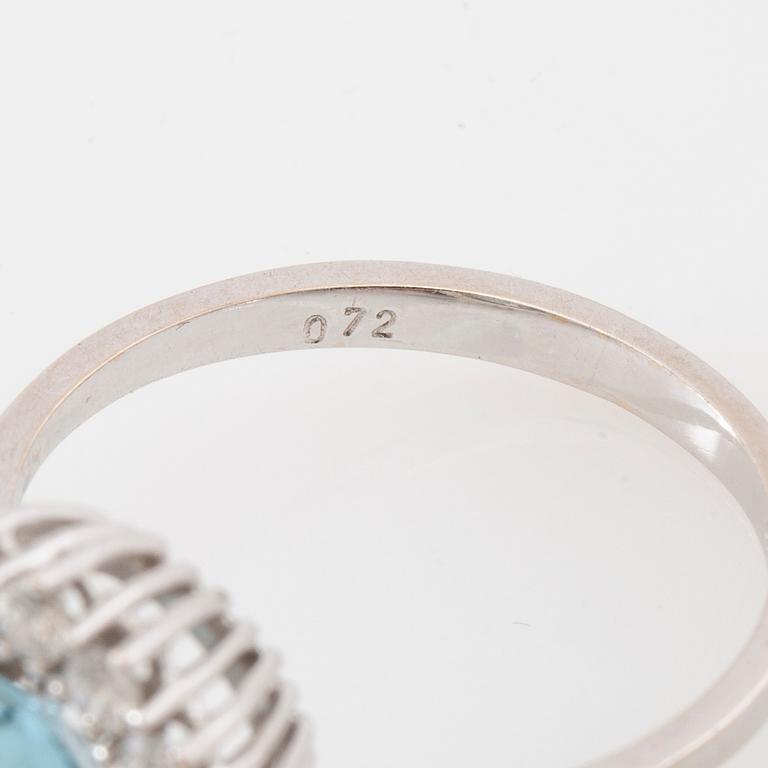 Ring 18K white gold set with an oval faceted aquamarine and round brilliant-cut diamonds.