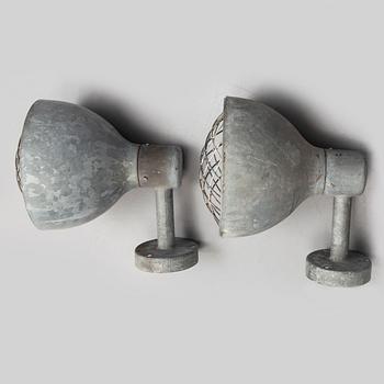 A pair of industrial wall lamps.