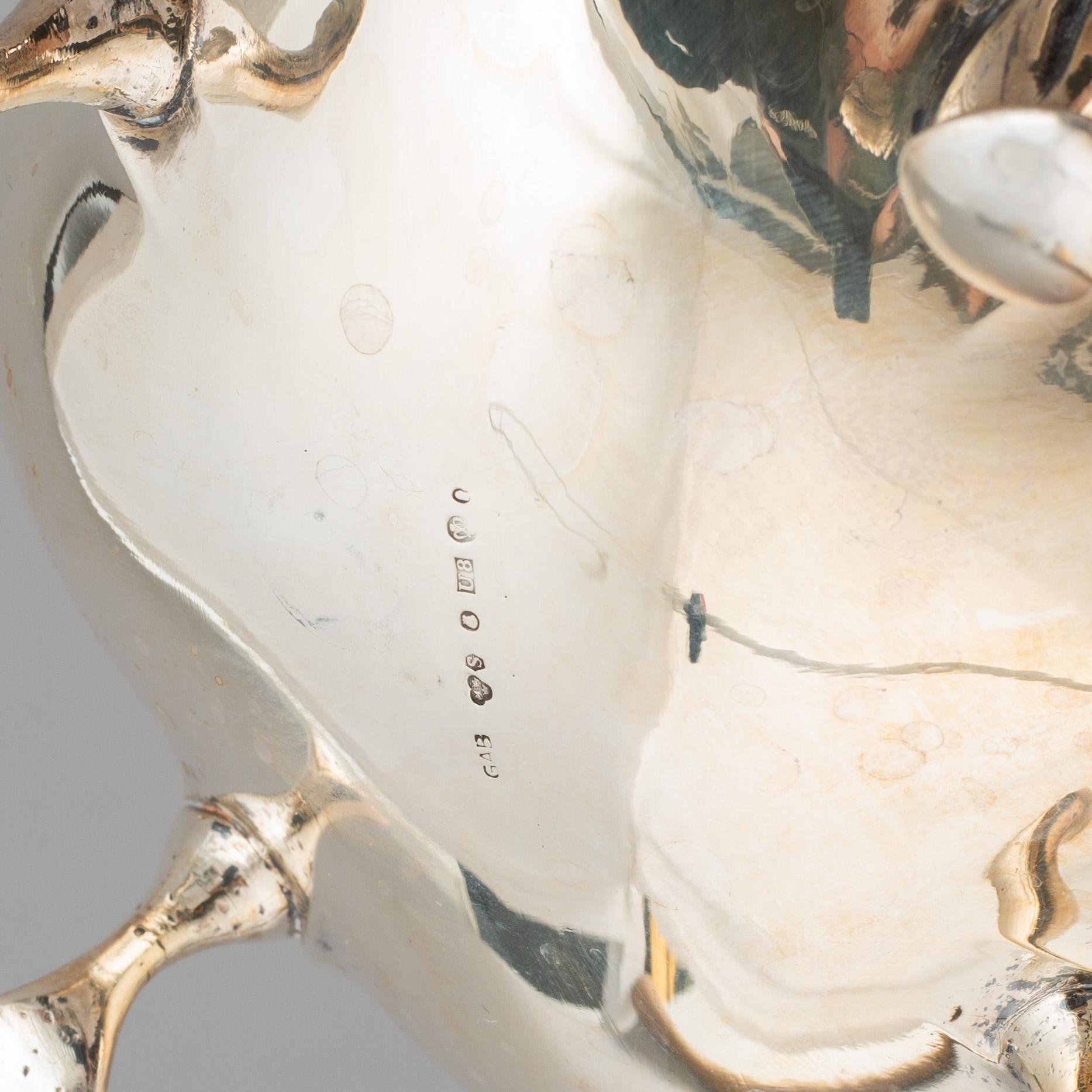 A silver coffee pot, creamer and sugar bowl and a pair of candlesticks, GAB Stockholm 1946 and Dacapo Lidköping 1988.