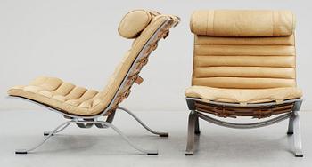 A pair of Arne Norell "Ari" brown leather and steel easy chairs by Norell.