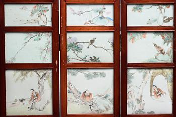 A Chinese folding screen with 48 porcelain tiles, late Qing dynasty, signed Ren Huanzhang, and dated 1881.