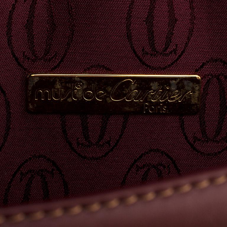 Wine-colored leather briefcase by Cartier.