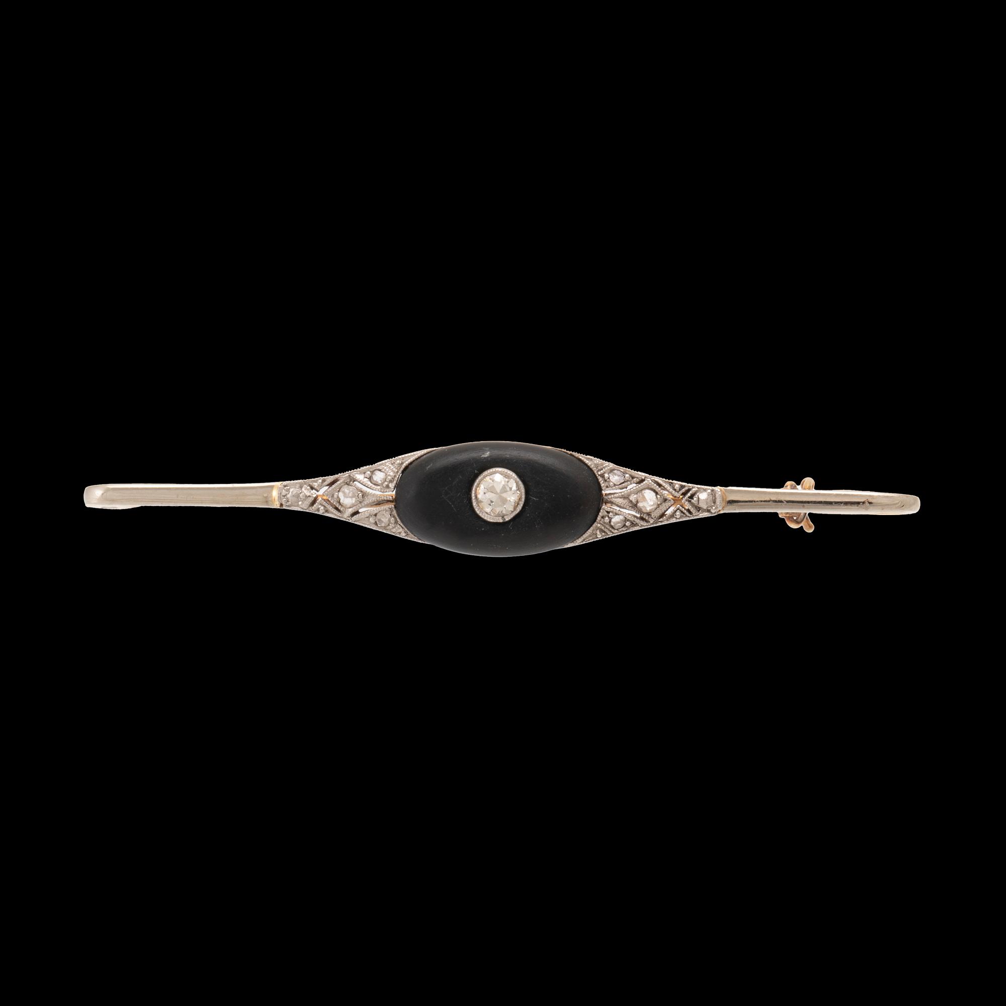 A 14K white and red gold brooch set with round brilliant-cut and rose-cut diamonds and a black stone.