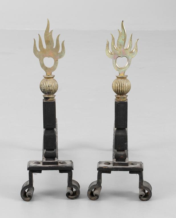 A pair of brass and cast iron firedogs, attributed to Petrus Forssberg, 1920's.