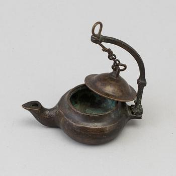 An 18th century bronze oil lamp.