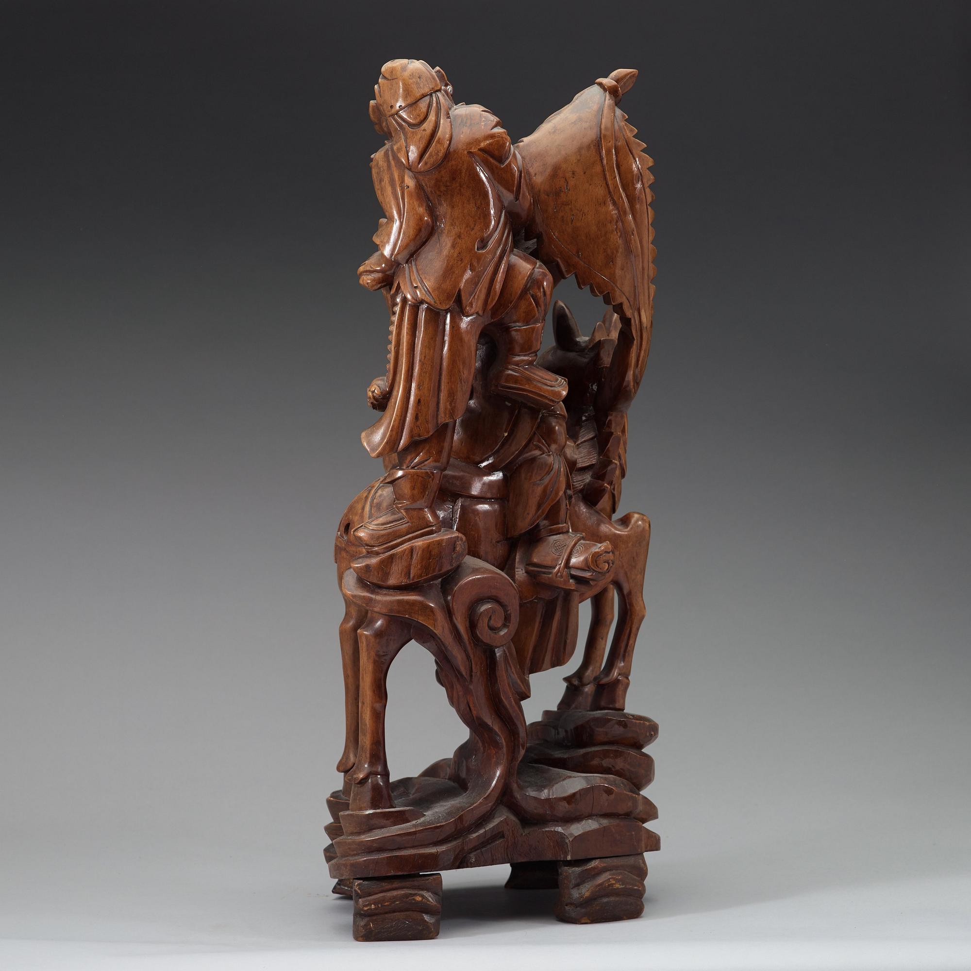 A large wooden sculpture group of Guandi on horseback and an attendant, Qing dynasty (1644-1912).