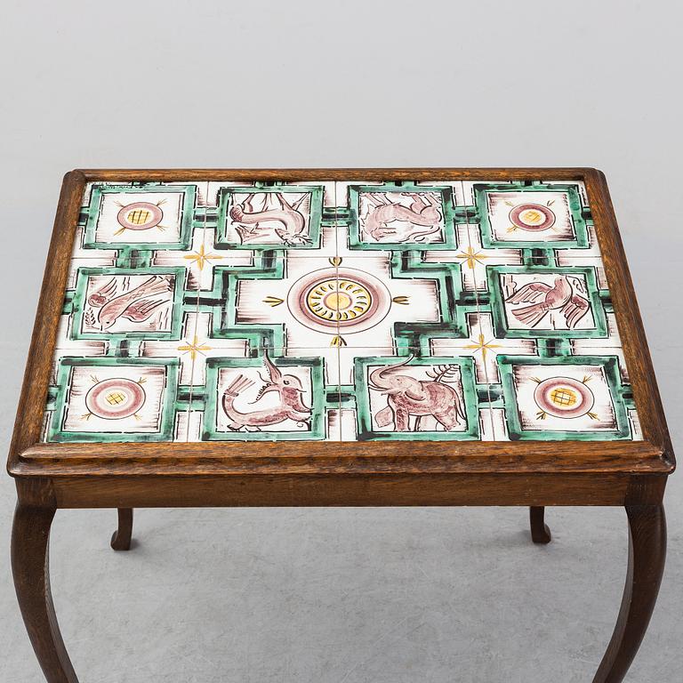 An oak table with glazed tiles by  Anna-Lisa Thomson, S.t Erik, dated 1931.