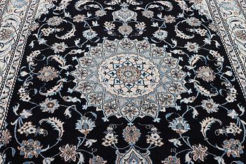 A Nain carpet, part silk, c. 286 x 206 cm.