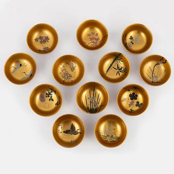 A silk clad box with twelve Japanese lacquer bowls, with dating inside the box 28/5 1930.