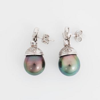 A pair of cultured Tahiti pearl and diamond earrings.