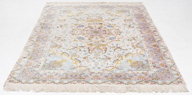 A Tabriz carpet north west Persia, part silk, c. 314 x 197 cm.