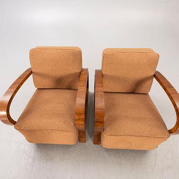 A pair of Art Deco walnut armchairs.