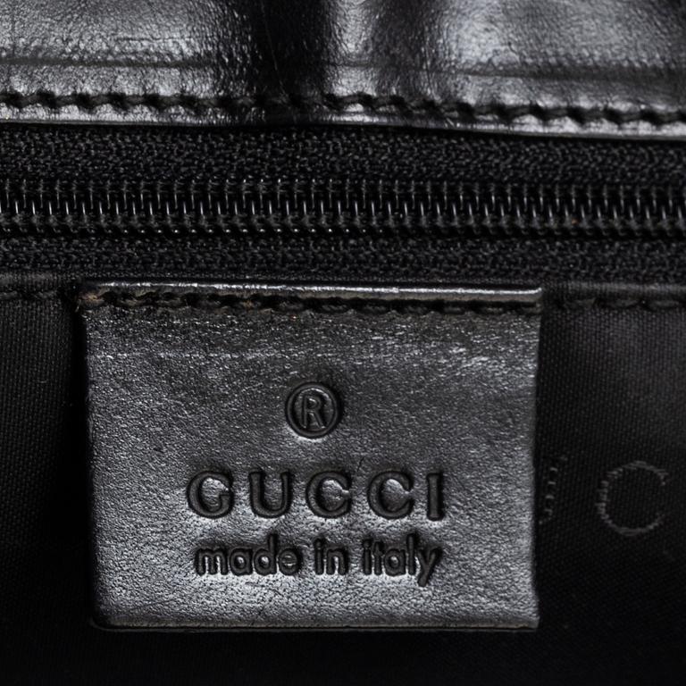 GUCCI, a leather and canvas bag.