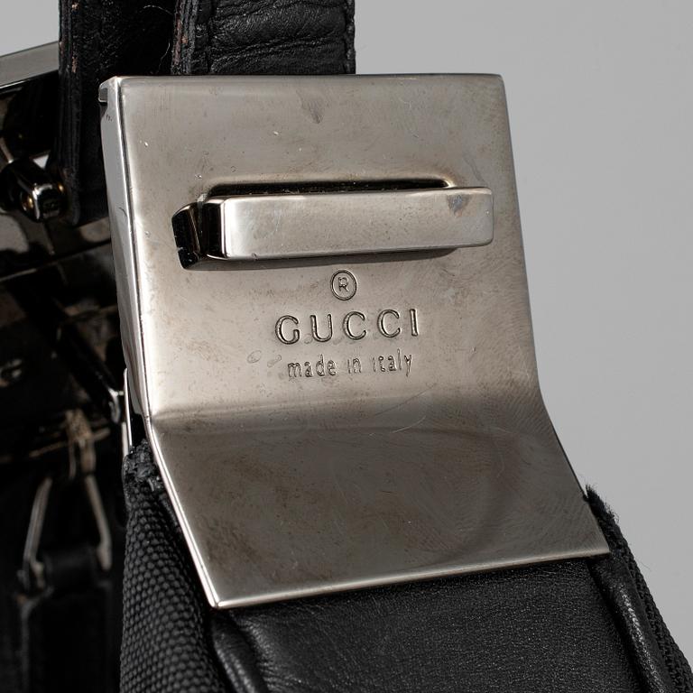 GUCCI, a canvas handbag.