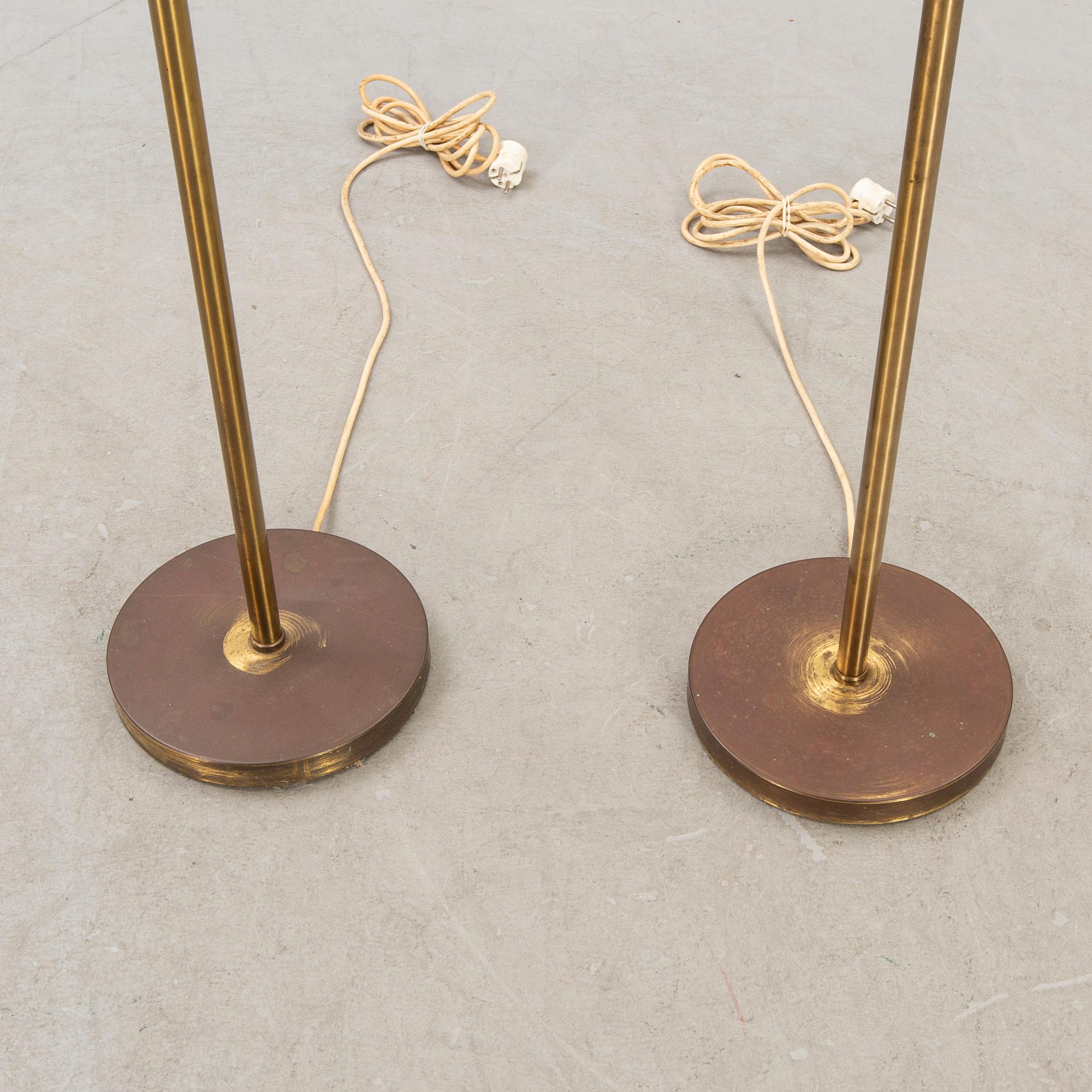 A pair of brass floor lamps from NK (Nordiska Kompaniet) later part of the 20th century.