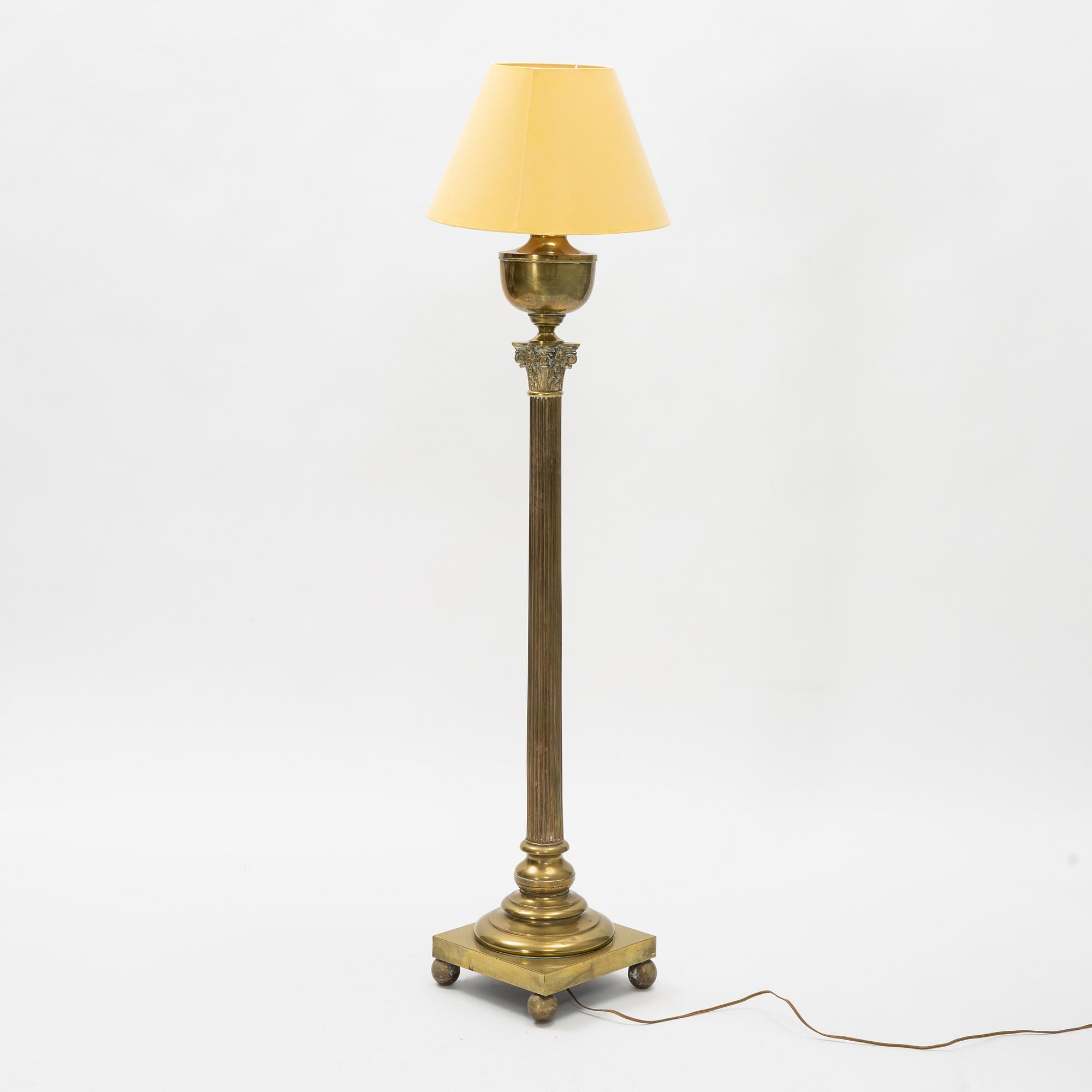 A brass floor lamp, circa 1900.