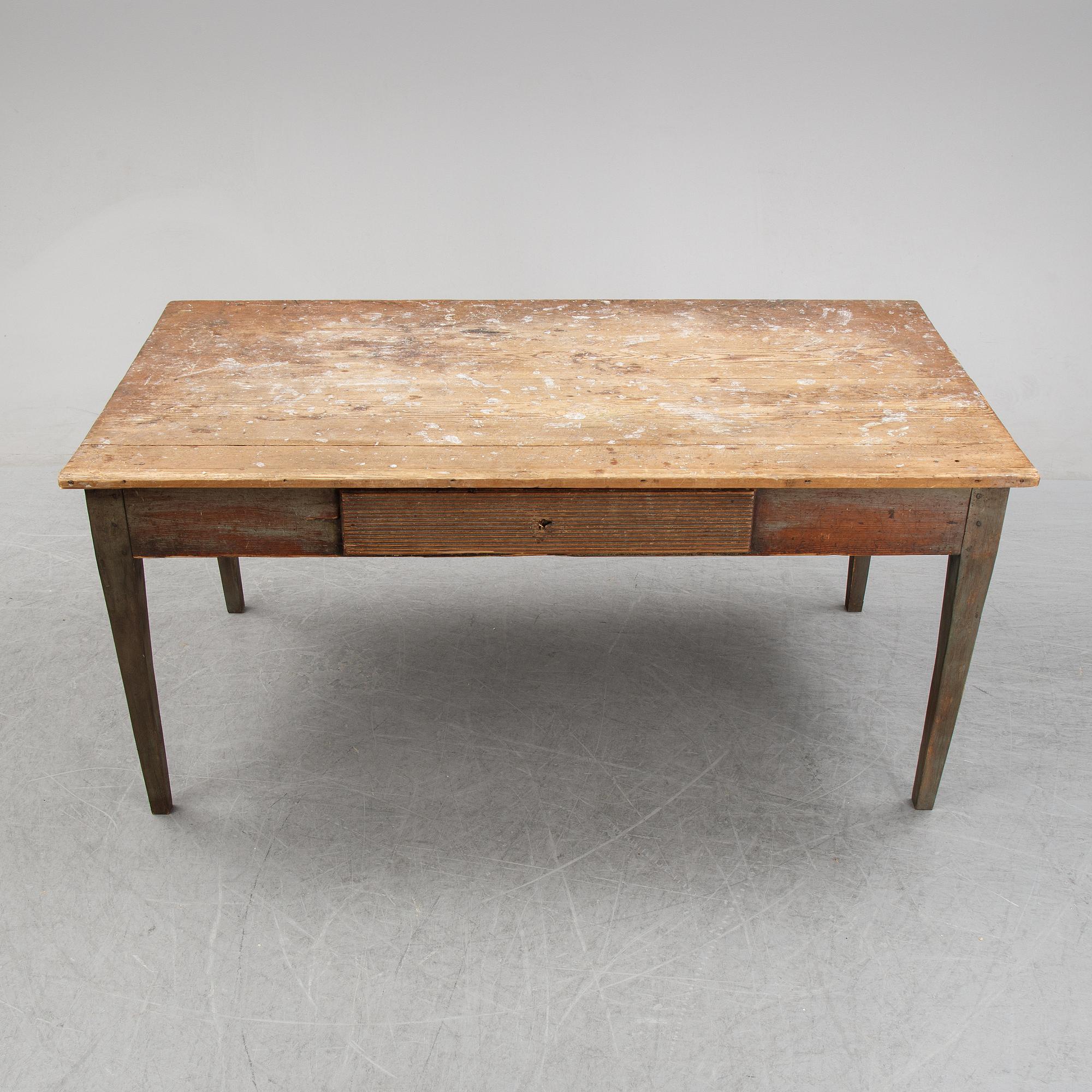 A 19th Century table with drawers.